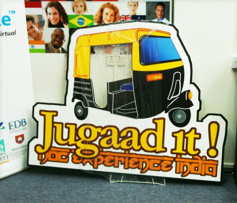 Portable foamboard standee being easily transported between marketing events by business professional