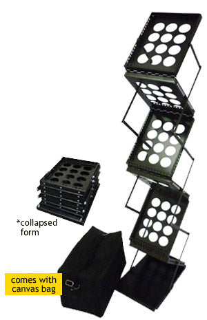 Professional Black Zig Zag Brochure Display Stand in use at trade show booth, displaying marketing materials with visitors browsing literature